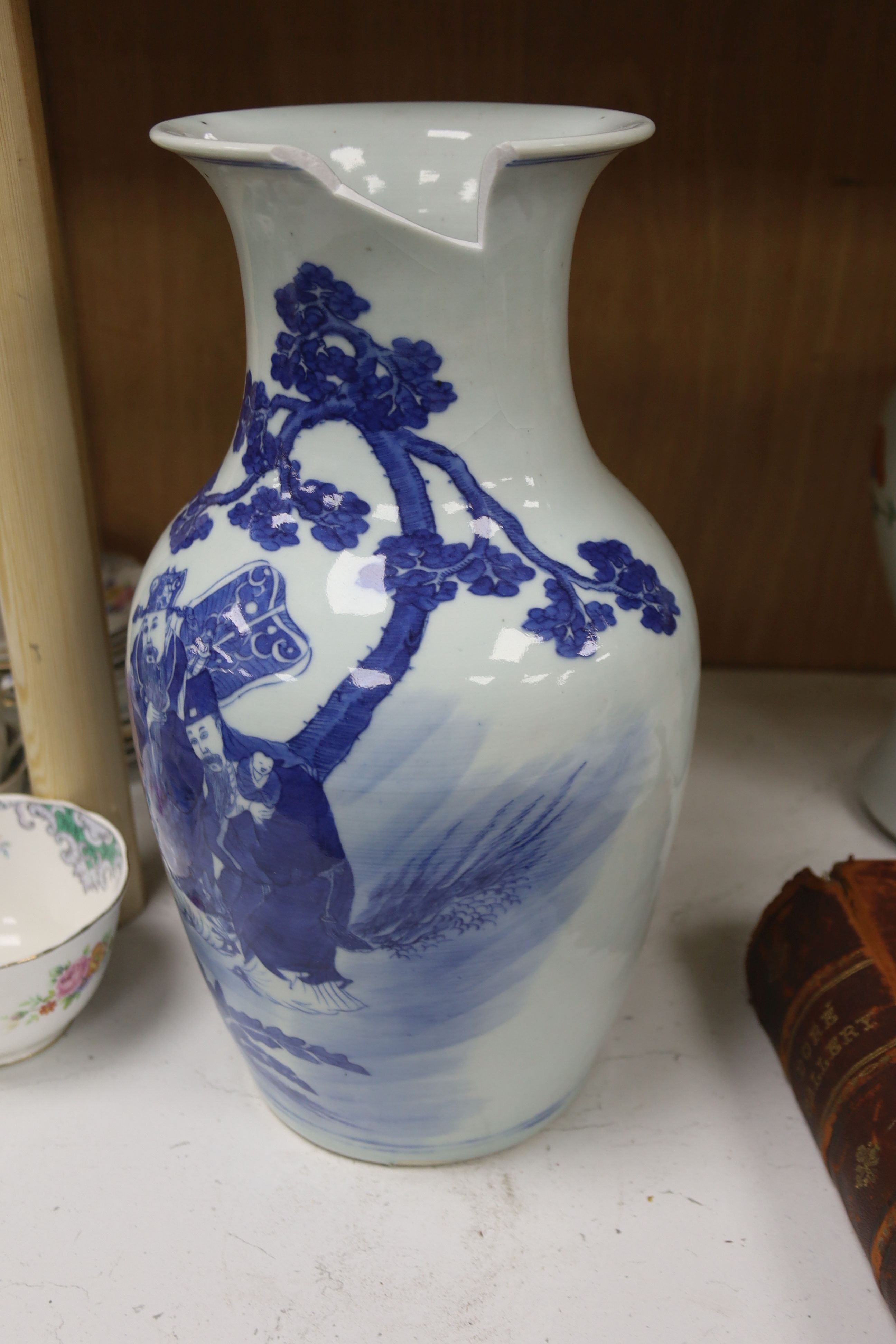 A Chinese blue and white 'Immortals' vase, 18th/19th century, damage, 34.5cm and a Chinese Yongzheng period famille rose ‘phoenix’ vase (reduced in height), 24cm
